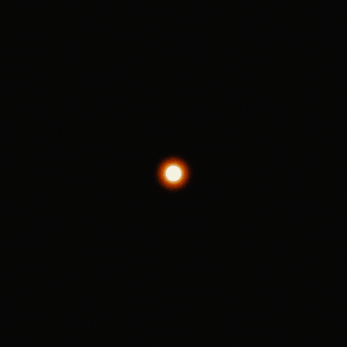 A bright white disc 16 px across on a dark background on Super 35 4-perf: the red-orange halo reaches about 15 px beyond the disc.
