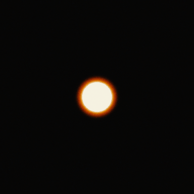 A bright white disc 58 px across on a dark background on Super 35 4-perf: the red-orange halo reaches about 15 px beyond the disc.